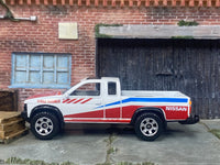 Matchbox 1995 Nissan Hardbody 4X4 Off Road Truck White, Red and Blue - rear angle view showing tampo details