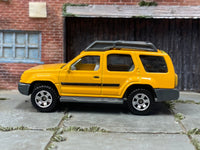 Matchbox 2000 Nissan XTerra Yellow - rear angle view showing tampo details