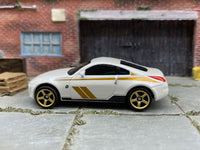 Matchbox 2003 Nissan 350Z White and Gold - rear angle view showing tampo details