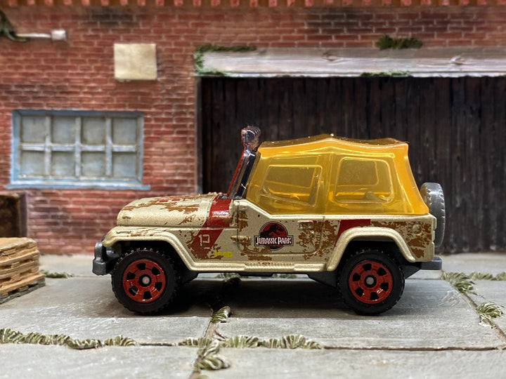 Matchbox Jeep Wrangler Jurassic Park Tour Jeep in Gold and Red with Yellow Top, loose diecast car