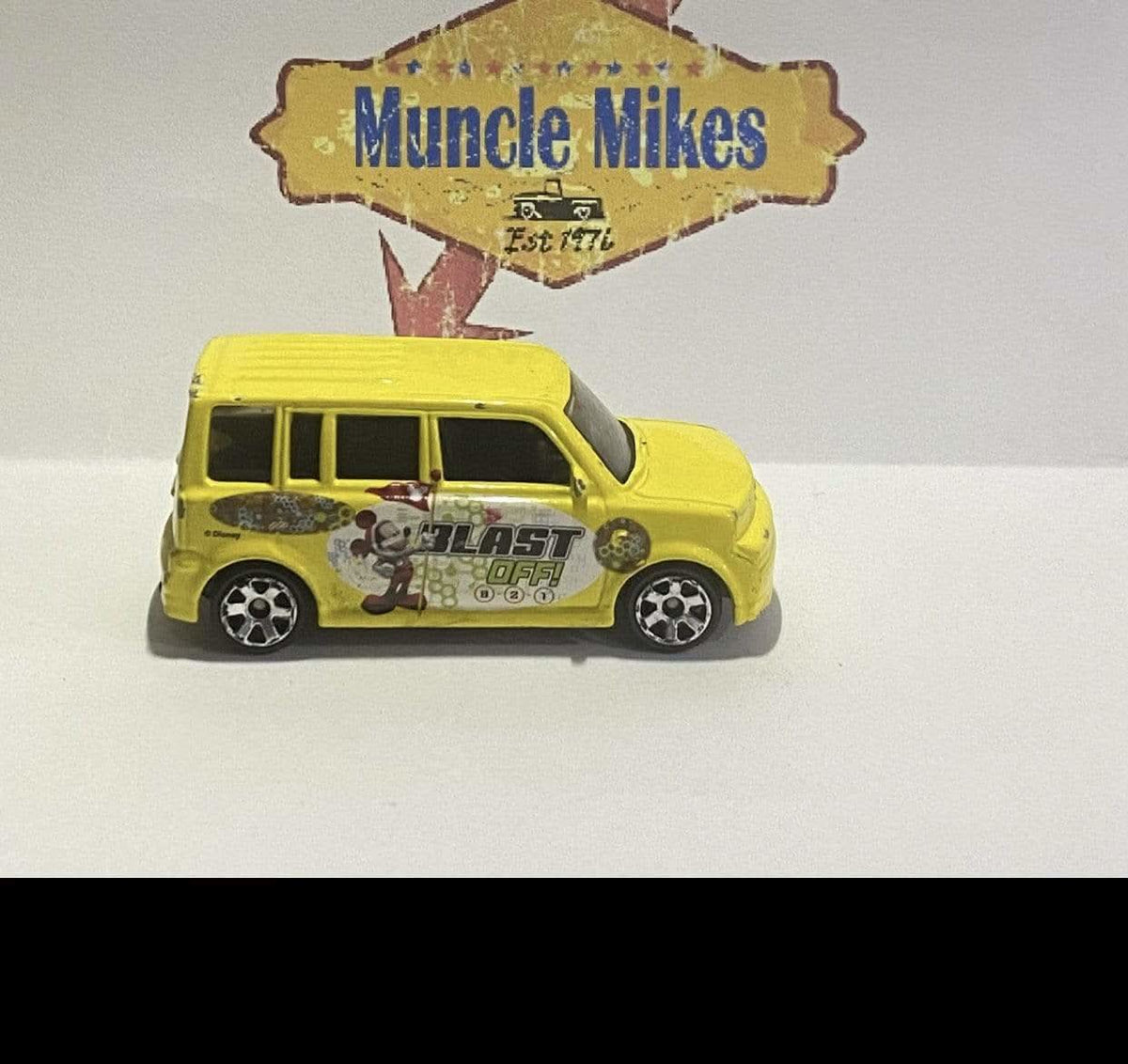 Yellow 2004 Matchbox Scion with Mickey Mouse Blast Off graphics, view 1